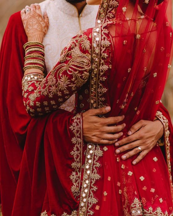Indian wedding couple in their red outfits